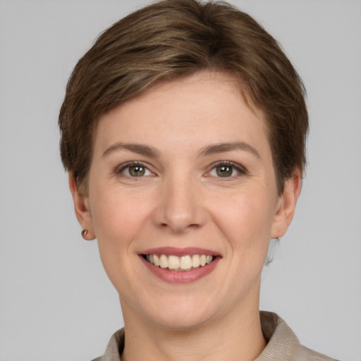 Joyful white young-adult female with short  brown hair and grey eyes