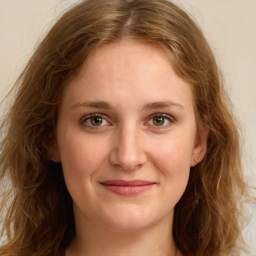 Joyful white young-adult female with long  brown hair and green eyes