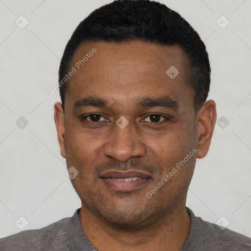Joyful black young-adult male with short  black hair and brown eyes