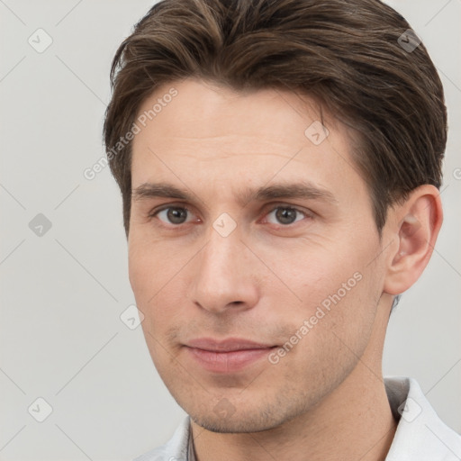 Joyful white young-adult male with short  brown hair and brown eyes