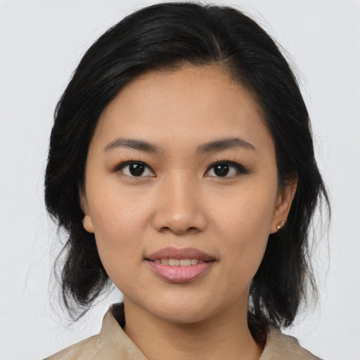 Joyful asian young-adult female with medium  brown hair and brown eyes