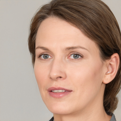 Joyful white adult female with medium  brown hair and grey eyes