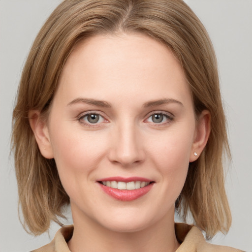 Joyful white young-adult female with medium  brown hair and blue eyes