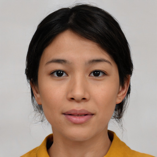 Joyful white young-adult female with medium  black hair and brown eyes