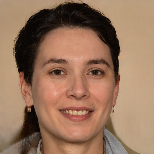 Joyful white young-adult female with medium  brown hair and brown eyes