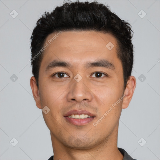 Joyful asian young-adult male with short  black hair and brown eyes