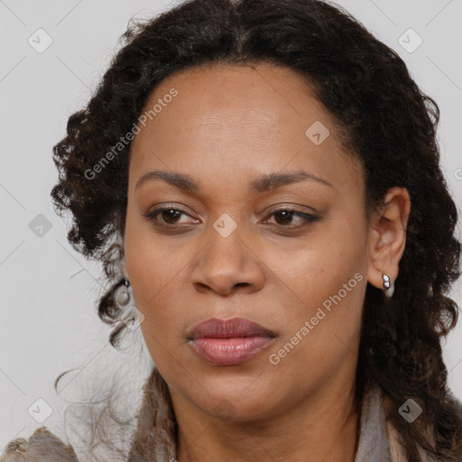 Joyful black adult female with medium  brown hair and brown eyes