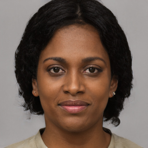 Joyful black young-adult female with medium  black hair and brown eyes