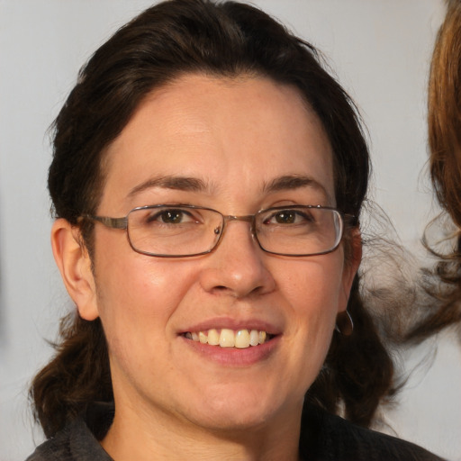 Joyful white adult female with medium  brown hair and brown eyes