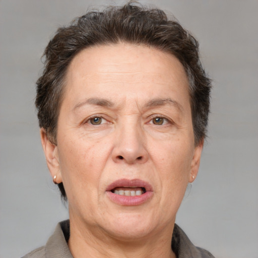 Joyful white middle-aged female with short  brown hair and brown eyes