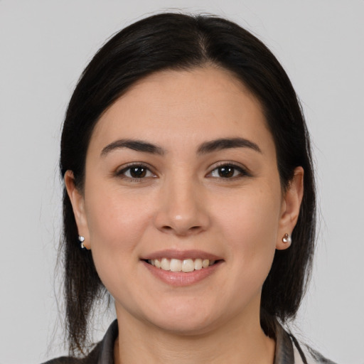 Joyful white young-adult female with medium  brown hair and brown eyes