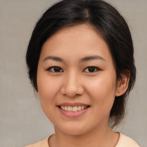 Joyful asian young-adult female with medium  brown hair and brown eyes