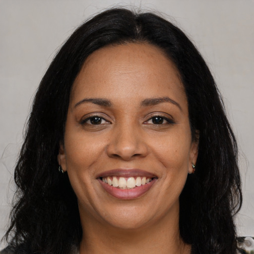 Joyful latino young-adult female with long  black hair and brown eyes