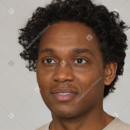 Joyful black adult male with short  black hair and brown eyes