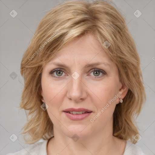 Joyful white adult female with medium  brown hair and blue eyes