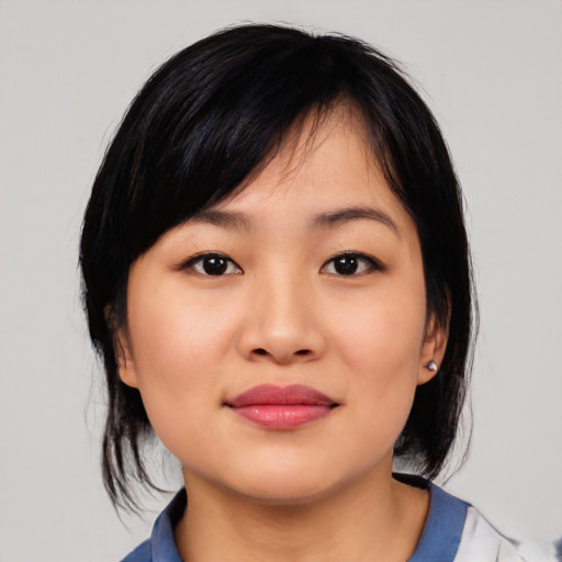 Joyful asian young-adult female with medium  black hair and brown eyes