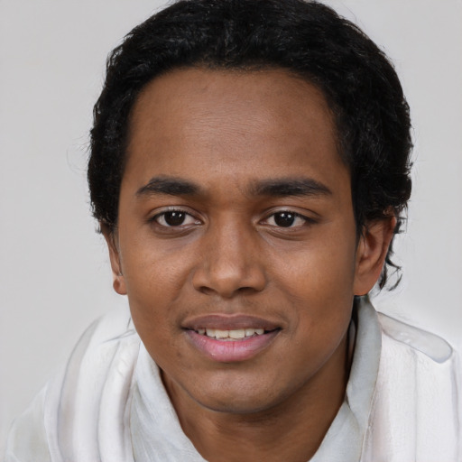 Joyful black young-adult male with short  black hair and brown eyes