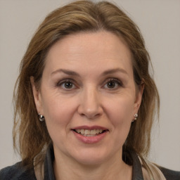 Joyful white adult female with medium  brown hair and brown eyes