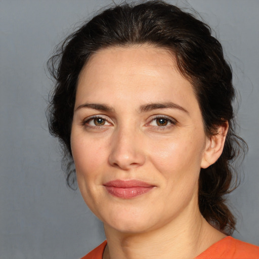 Joyful white adult female with medium  brown hair and brown eyes