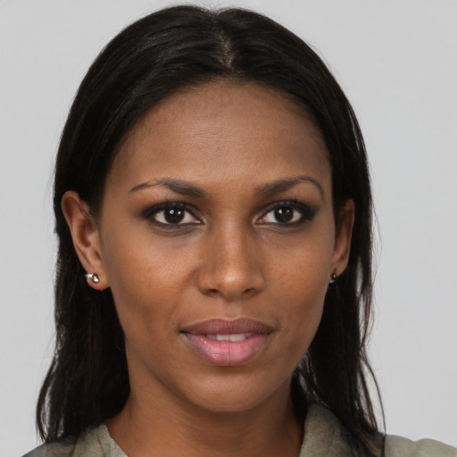 Joyful black young-adult female with long  brown hair and brown eyes