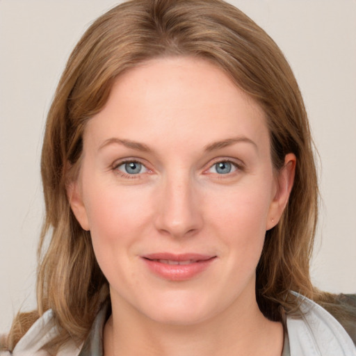 Joyful white young-adult female with medium  brown hair and blue eyes