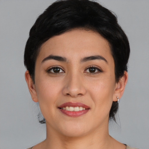 Joyful asian young-adult female with short  black hair and brown eyes