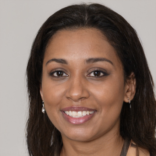 Joyful black young-adult female with medium  brown hair and brown eyes