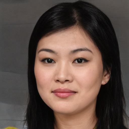 Joyful asian young-adult female with long  black hair and brown eyes