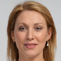 Joyful white adult female with long  brown hair and grey eyes