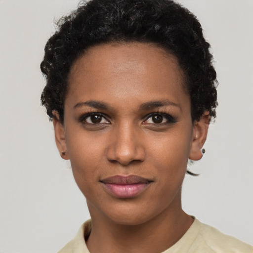 Joyful black young-adult female with short  black hair and brown eyes