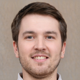 Joyful white young-adult male with short  brown hair and brown eyes