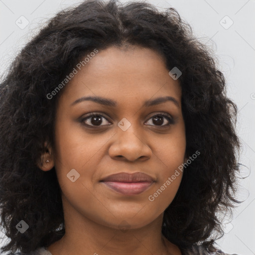 Joyful black young-adult female with long  brown hair and brown eyes