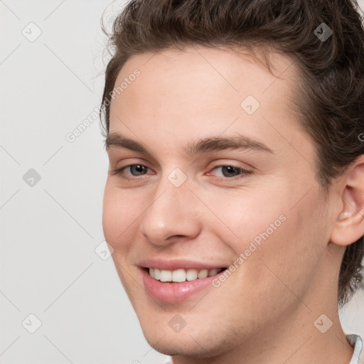 Joyful white young-adult male with medium  brown hair and brown eyes