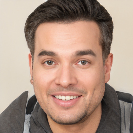 Joyful white young-adult male with short  brown hair and brown eyes