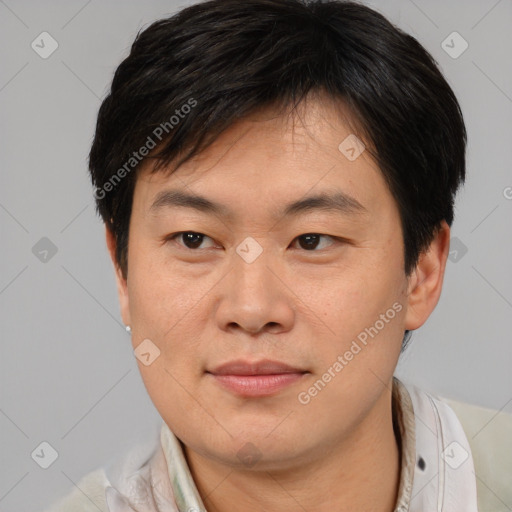 Joyful asian adult male with short  brown hair and brown eyes