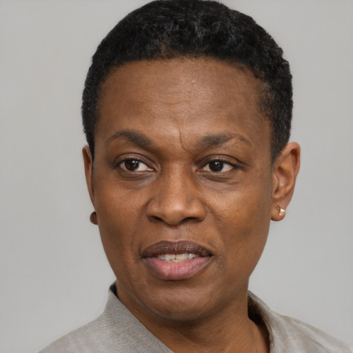 Joyful black adult male with short  black hair and brown eyes