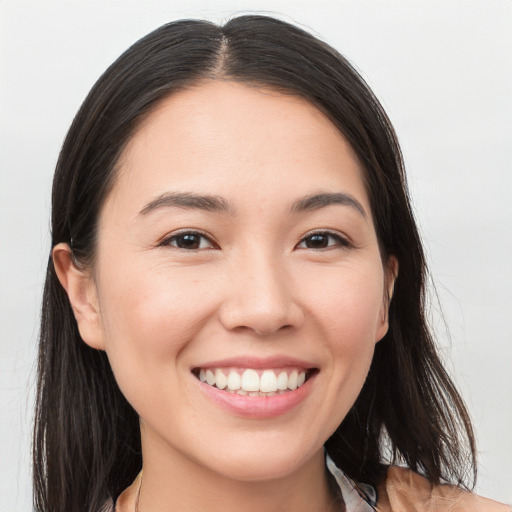 Joyful white young-adult female with long  brown hair and brown eyes