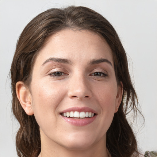 Joyful white young-adult female with medium  brown hair and grey eyes