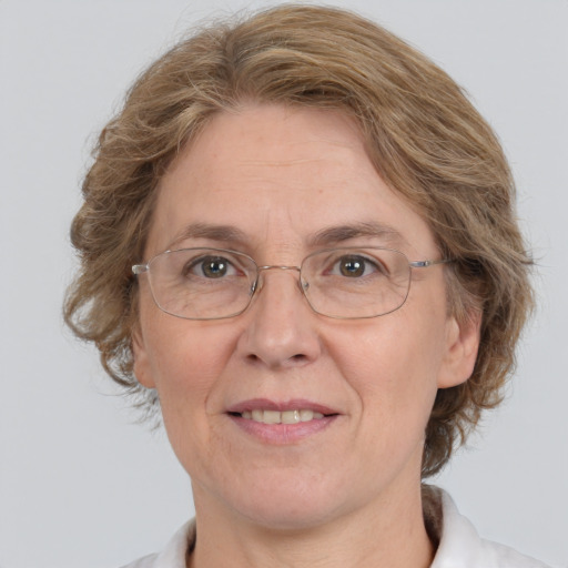 Joyful white middle-aged female with medium  brown hair and grey eyes