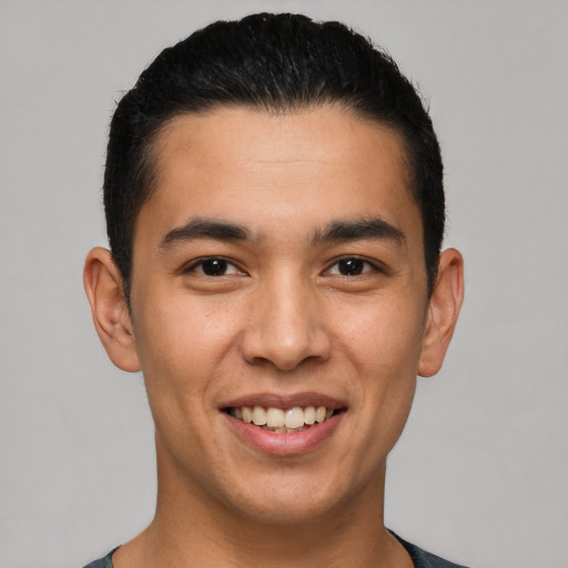 Joyful latino young-adult male with short  black hair and brown eyes