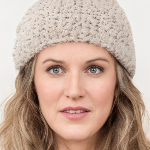 Joyful white young-adult female with long  brown hair and blue eyes