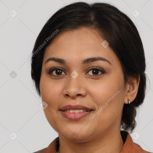 Joyful latino young-adult female with medium  brown hair and brown eyes