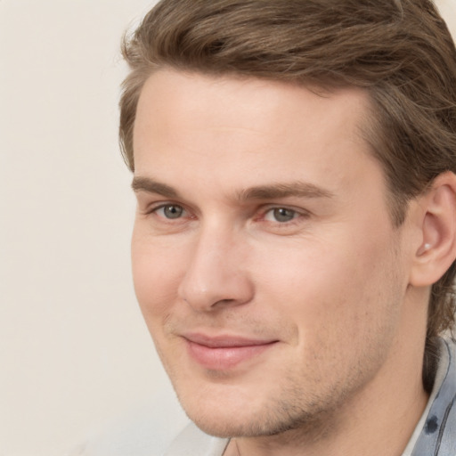 Joyful white young-adult male with medium  brown hair and brown eyes