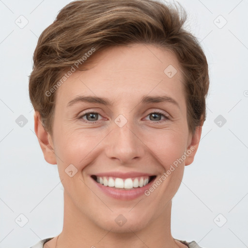 Joyful white young-adult female with short  brown hair and grey eyes