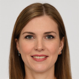 Joyful white young-adult female with long  brown hair and green eyes