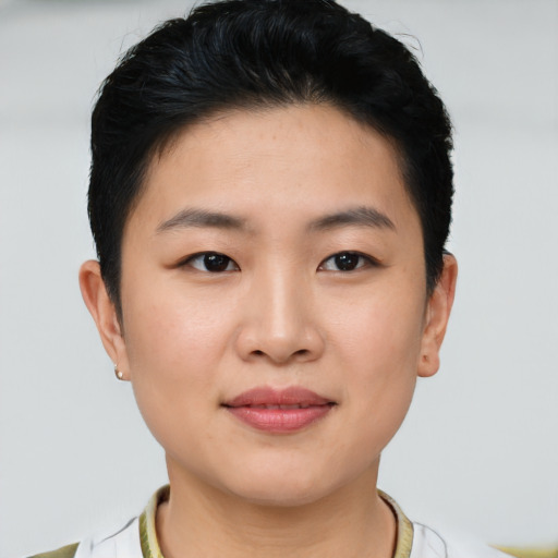 Joyful asian young-adult female with short  brown hair and brown eyes