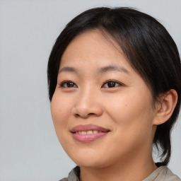 Joyful asian young-adult female with medium  brown hair and brown eyes