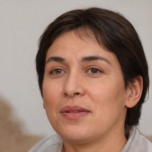 Joyful white adult female with medium  brown hair and brown eyes