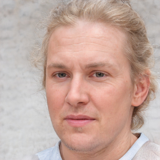 Joyful white adult male with short  brown hair and blue eyes