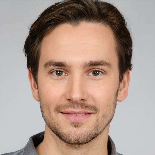 Joyful white young-adult male with short  brown hair and brown eyes